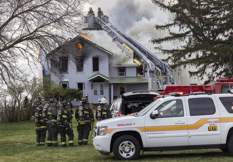 Firefighters battle a house fire Monday, April 14, 2025, at 1308 Harmon Road.