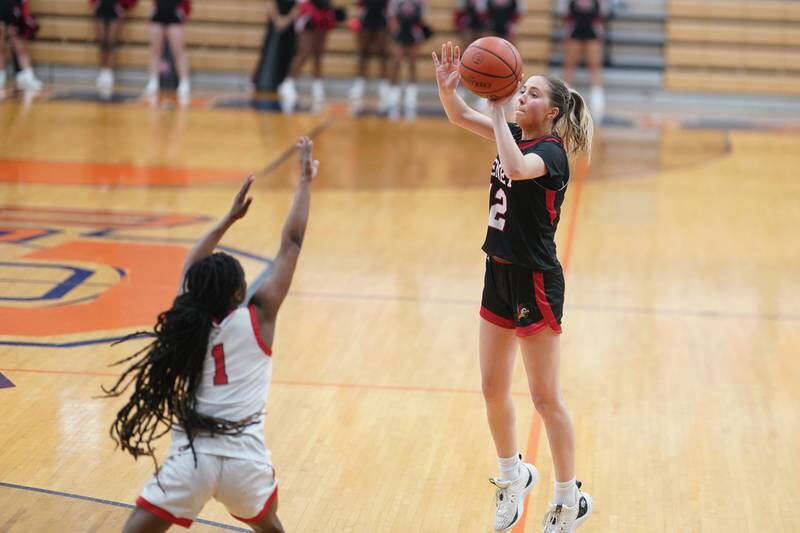 Benet’s Lindsay Harzich (12) shoots a three pointer against Bolingbrook's Airyel Jackson (1) during a Oswego semifinal sectional 4A basketball game at Oswego High School on Tuesday, Feb 20, 2024.