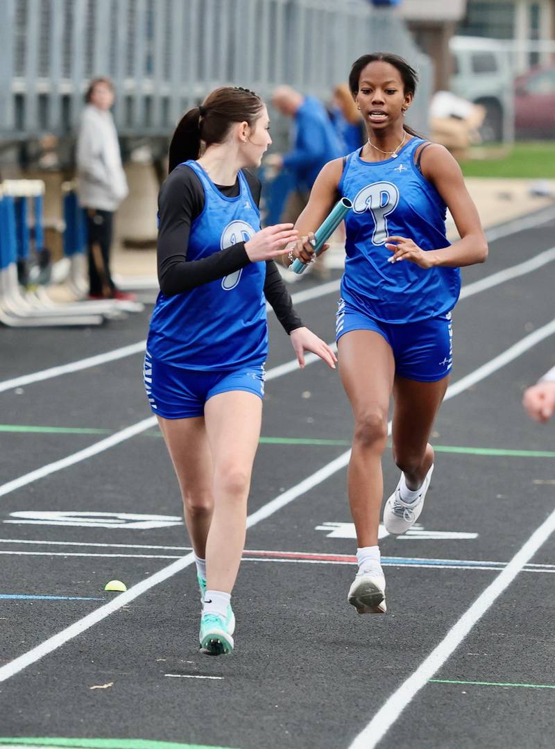 Princeton's  Kinley Fogarty takes the baton from Kieara Knupp in Thursday's Howard-Monier Meet at Princeton.
