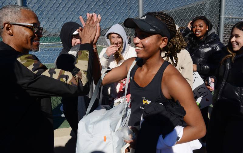 Hinsdale South's Chloe Goins high-fives her dad, Cliff, after winning the Class 1A singles during championship match of the girls state tennis tournament at Hersey High School on Saturday, Oct. 26, 2024 in Arlington Heights.