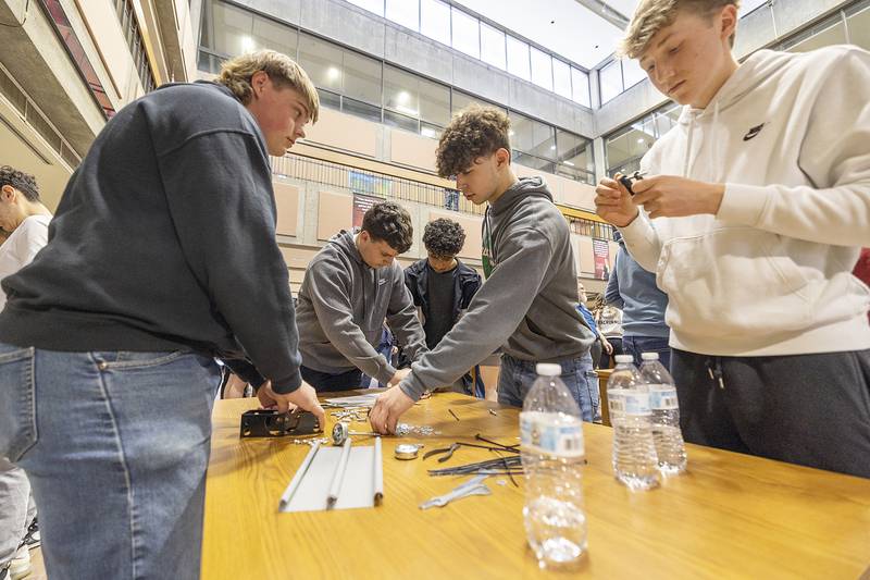 Rock Falls students Jacob Holler (left), Jacob Drawyer, Carlos Lira, Issac Duchy and Ajay Kobbeman get to work building a car Friday, April 26, 2024 during SVCC’s Manufacturing Day. Earlier in the day students toured 2 of 9 local manufacturing businesses.