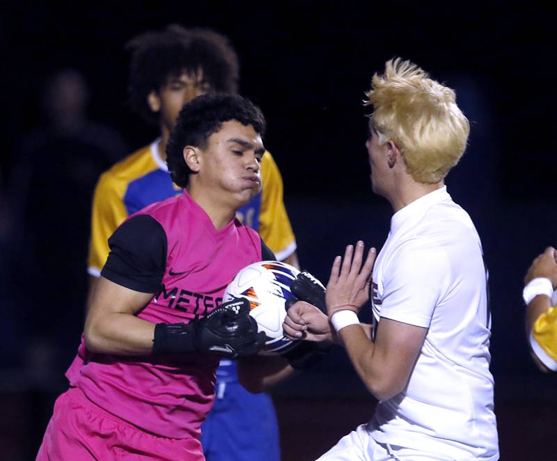 Chicago De La Salle's Jahir Anaya runs into Prairie Ridge's Samuel Kirk after he grabbed the ball during an IHSA Class 2A state semifinal soccer match on Friday, Nov. 8, 2024, at Hoffman Estates High School.