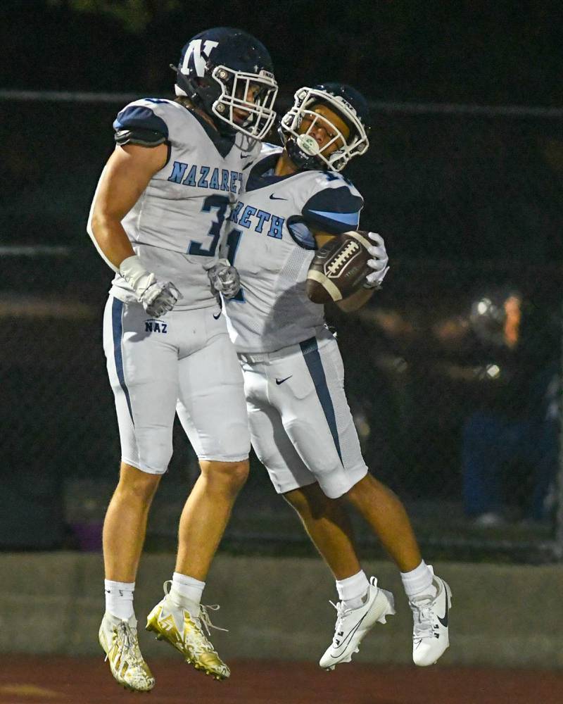 Nazareth Academy Jaden Fauske (3) celebrates with teammate Nazareth Academy James Penley after James scored a touchdown in the first quarter Friday 1, 2023 in Elmhurst.