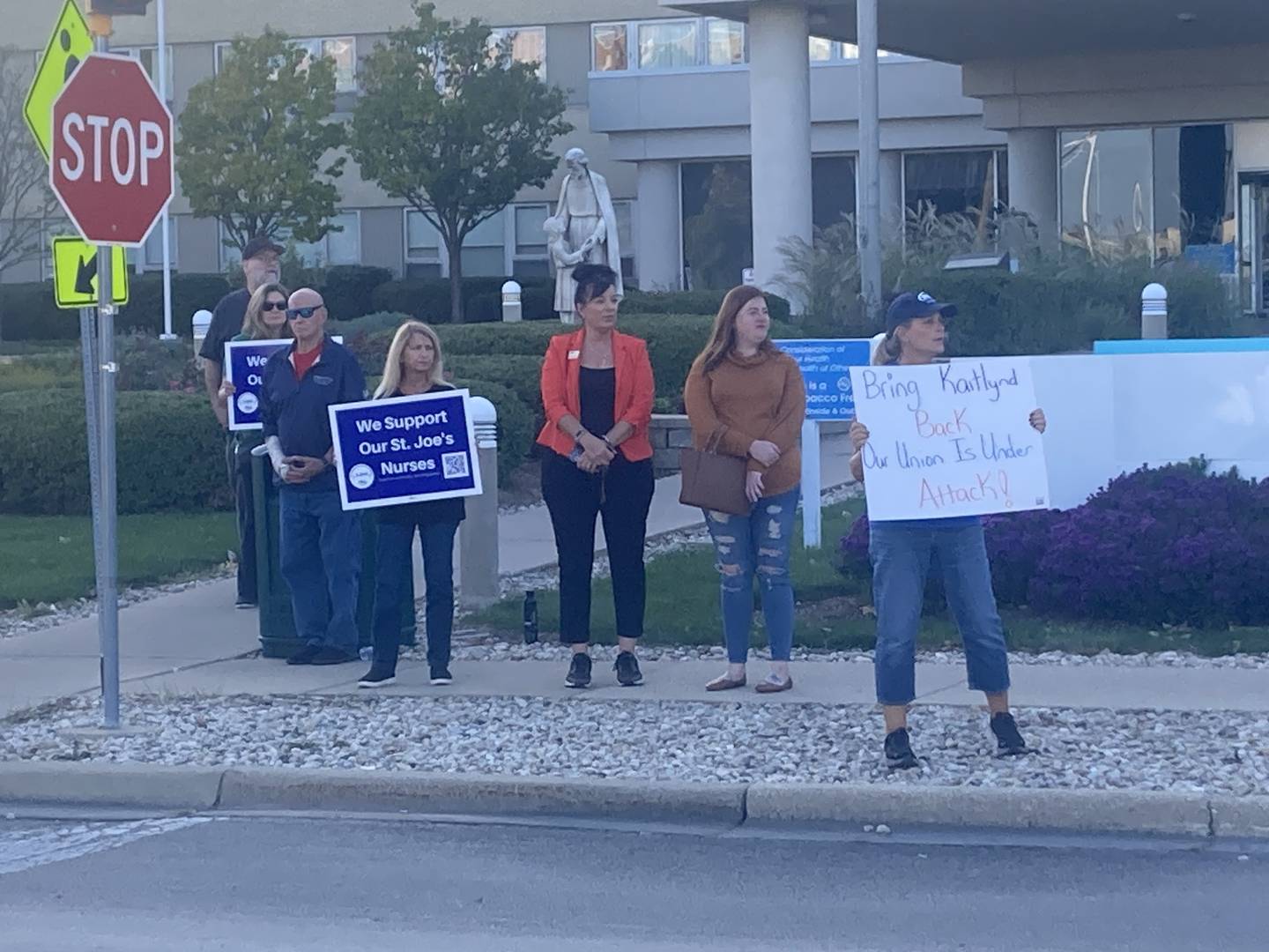 Kaitlynd French stands with Joliet City Council Woman Suzanna Ibarra and other union members outside Ascension St. Joseph--Joliet.