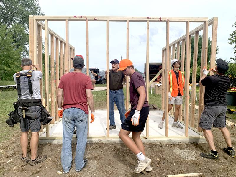 Volunteers work with Sugar Grove resident Christopher Eby (center) to replace a dilapidated shed for the Sugar Grove United Methodist Church (SGUMC). The project was Eby’s his Eagle Project for Sugar Grove Boys Scouts of America Troop No. 41.