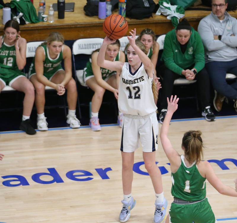 Marquette's Lily Craig shoots a wide-open three point basket as Seneca's Alyssa Zellers defends in Bader Gym on Monday, Jan. 23, 2023 at Marquette High School.