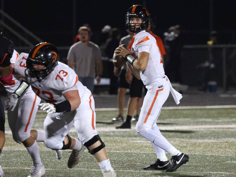 Lincoln-Way West's Grant Tustin looks for a receiver during their game Friday, Oct. 3, 2025, at DeKalb High School.