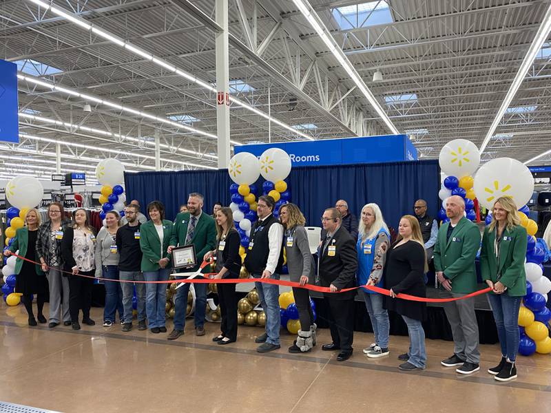 Walmart employees and members of the Ottawa Area Chamber of Commerce cut a ceremonial ribbon Friday, Nov. 18, 2022, celebrating the newly-renovated Walmart.
