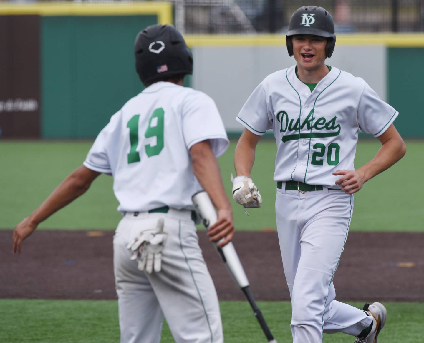 Joe Lewnard/jlewnard@dailyherald.com
York’s Ryan Turner, right, is greeted near the plate by teammate Chris Danko, who he drove in with a sacrifice fly during the Class 4A state third-place baseball game in Joliet Saturday.