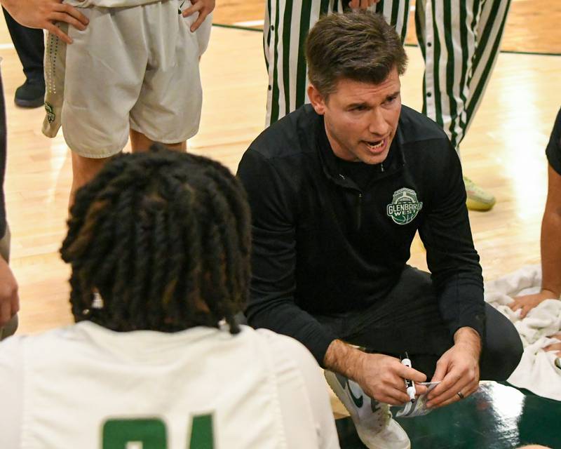 Glenbard West's head coach Jason Opoka talks to the team between quarters on Wednesday Nov. 26, 2025, while taking on Glenbard East during the District 87 Thanksgiving Invitational held at Glenbard West High School.