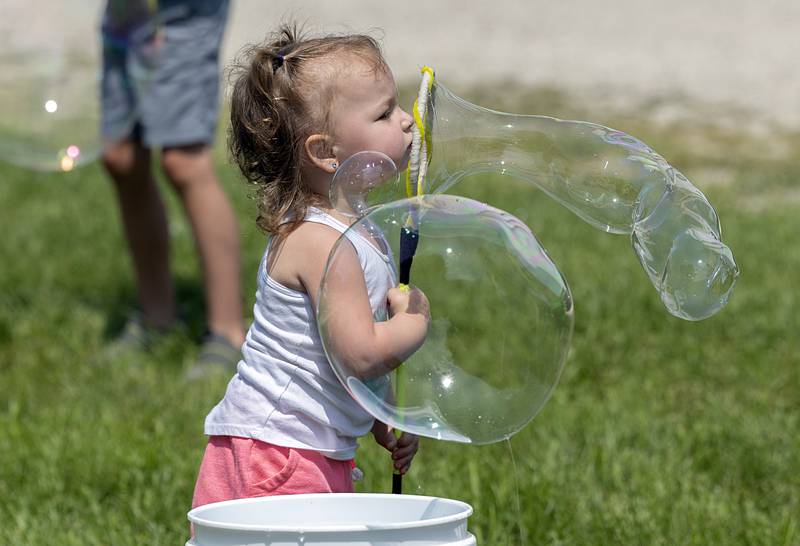 Lily Bryan, 2, blows a big bubble Sunday, July 21, 2024 while having fun at Tampico Days.