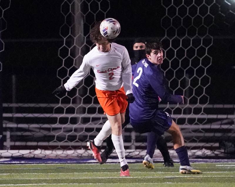 St. Charles East's Brandon Garland (right) heads the ball against New Trier's Yannick Vaughan during the class 3A St. Charles North Boys Soccer Supersectional match at St. Charles North High School on Wednesday, Nov. 1, 2023.