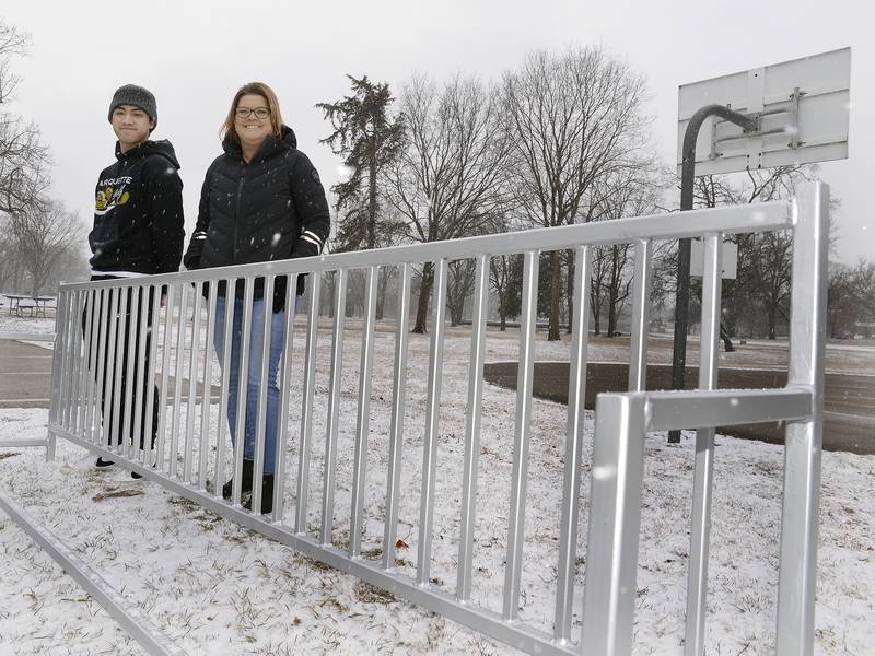 Marquette Academy senior Ben Weyer stands with Commissioner Marla Pearson on Thursday, March 10, 2022, at the bike stand he built at Fox River Park in Ottawa. The bike stand installation was his Eagle Scout project.