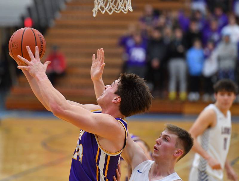 Downers Grove North's George Wolkow (top) does a reverse layup in front of Lyons Township's Graham Smith during a game on Jan. 6, 2023 at Lyons Township High School in LaGrange.