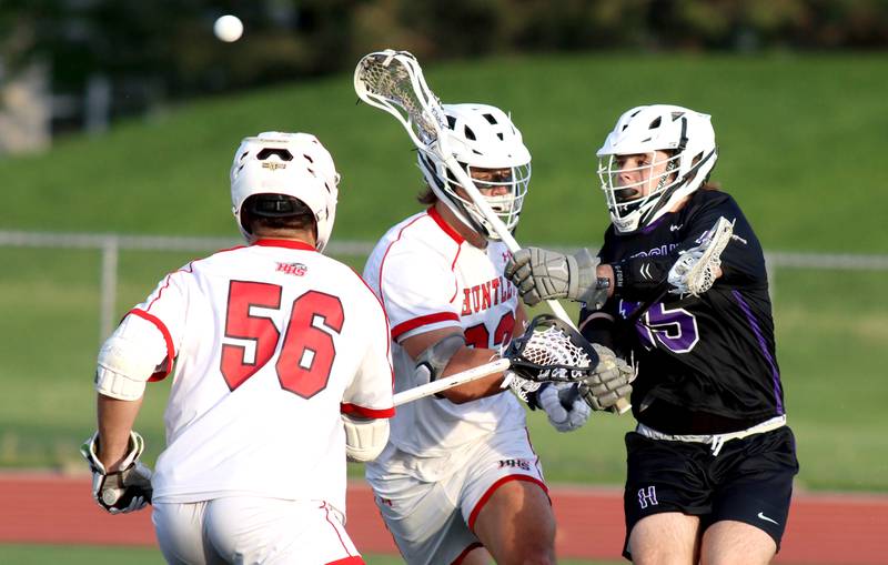 Hampshire’s  Cambell Smith, right, passes the ball in varsity lacrosse at Huntley Thursday night.