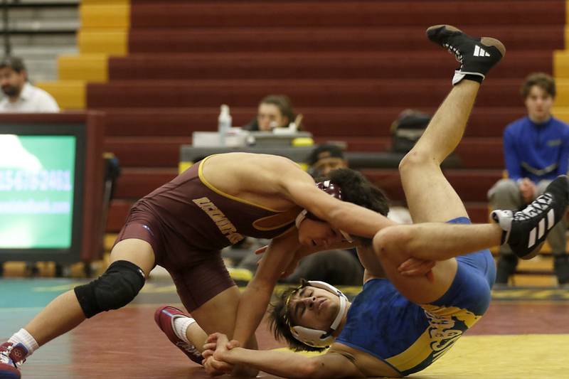 Richmond-Burton's Kyan Gunderson tries to take down Johnsburg's Jack Thompson during the 126-pound match of a Kishwaukee River Conference wrestling match on Thursday, Jan. 25, 2024, at Richmond-Burton High School.