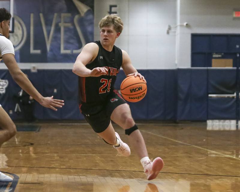 Yorkville's Frankie Pavlik (21) makes move to the basket during their basketball game between Yorkville at Oswego East. Friday, Dec 19, 2025 in Oswego.