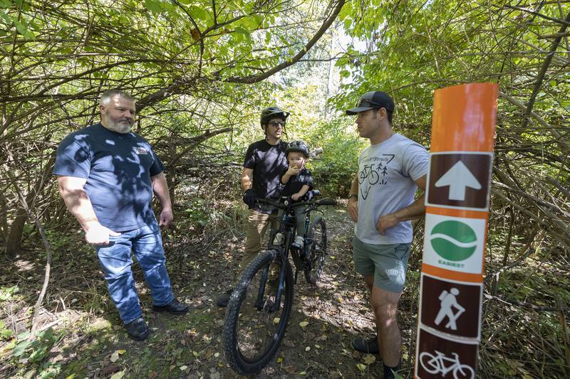 Rock River Valley Bike Club members Brian Seagren (left), Scott Fenwick and son Leo and Ryan Elmendorf talk about the work the group puts in to maintain the trails in Dixon on Saturday, Sept. 28, 2024.