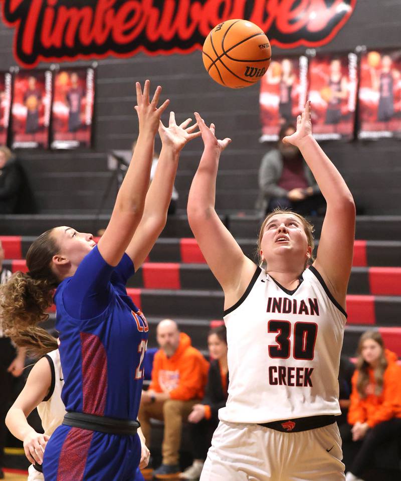 Indian Creek's Madison Boehne and Genoa-Kingston's Regan Creadon try to grab a rebound Monday, Dec. 8, 2025, during their game at Indian Creek High School in Shabbona.