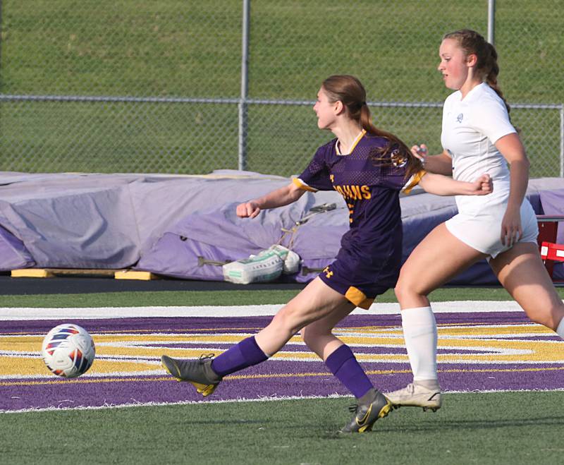 Mendota's Emily Stewart kicks the ball toward the goal as Princeton's Anagrace Isaacson defends during the Class 1A Regional semifinal game on Tuesday, May 9, 2023 at Mendota High School.