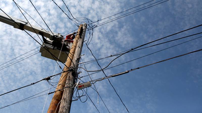 A lineman for the Batavia Electric Department services overhead power lines on Harrison Street.