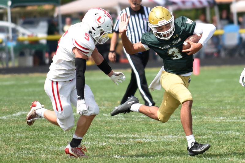 Bishop McNamara's Micah Lee, right, stiff arms Lawrencville's Zachary Coffey during a game at Bishop McNamara Saturday, Aug. 30, 2025.