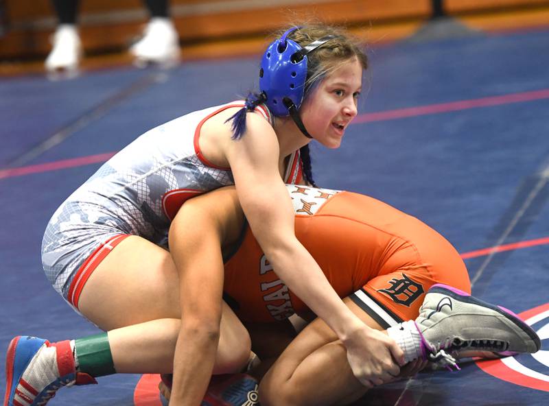 Oregon's Kendra Ege (top) looks to her coach as she battles DeKalb's Alex Gregorio-Perez in the 100-pound championship match at the Belvidere Regional on Saturday, Feb. 7, 2026. Gergorio-Perez won the match.