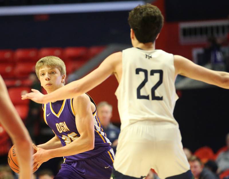 Downers Grove North's Ian Brown looks to pass the ball over New Trier's Logan Feller in the Class 4A state third place game on Friday, March 10, 2023 at the State Farm Center in Champaign.