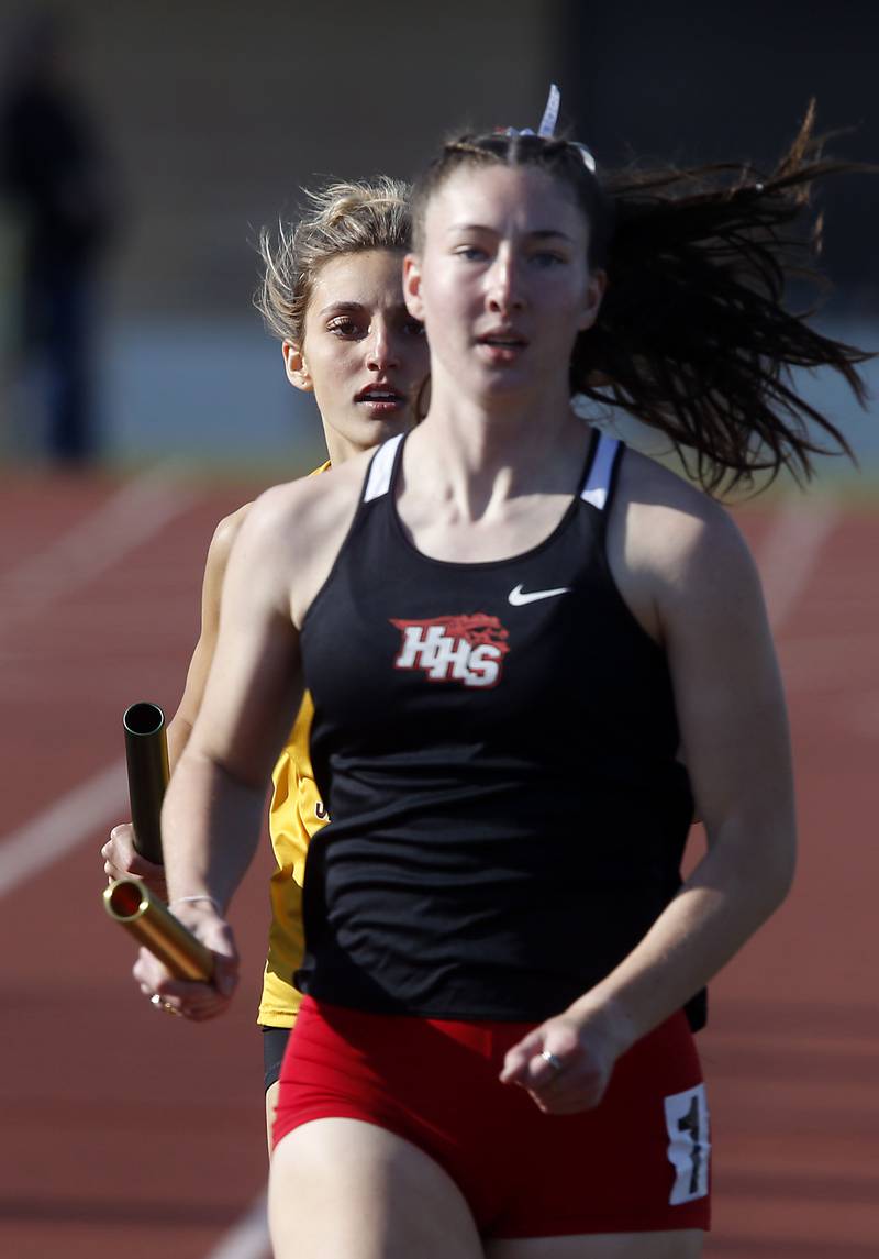 Huntley’s Morgan Sauber is chased by Jacobs’ Mackenzie Cronin as they run the last leg of the 4x800 meter relay on Thursday, May 7, 2026, during the Fox Valley Conference Girls Track and Field Meet at Huntley High School.