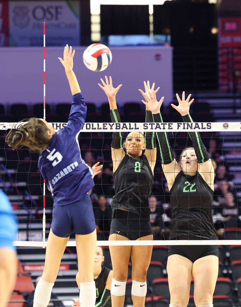 Providence's Demi Carbone, center, and Grace Lustig jump to block a hit by Nazareth's Beth Surowiec during Nazareth's victory in two sets, 25-16, 25-17, over Providence in the IHSA Class 3A State semifinals on Friday, Nov. 14, 2025.