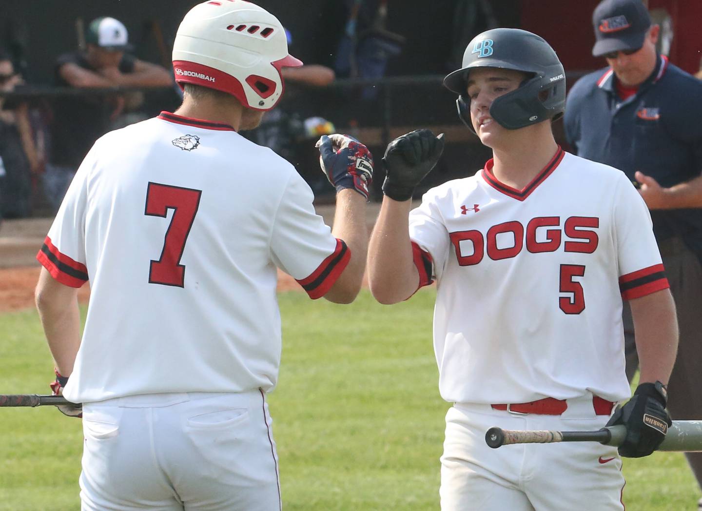 Streator's Landon Muntz (7) fist-bumps teammate Adam Williamson (5) after Williamson scored the first run against Peoria Richwoods in the first inning Wednesday, May 31, 2023, in Metamora.