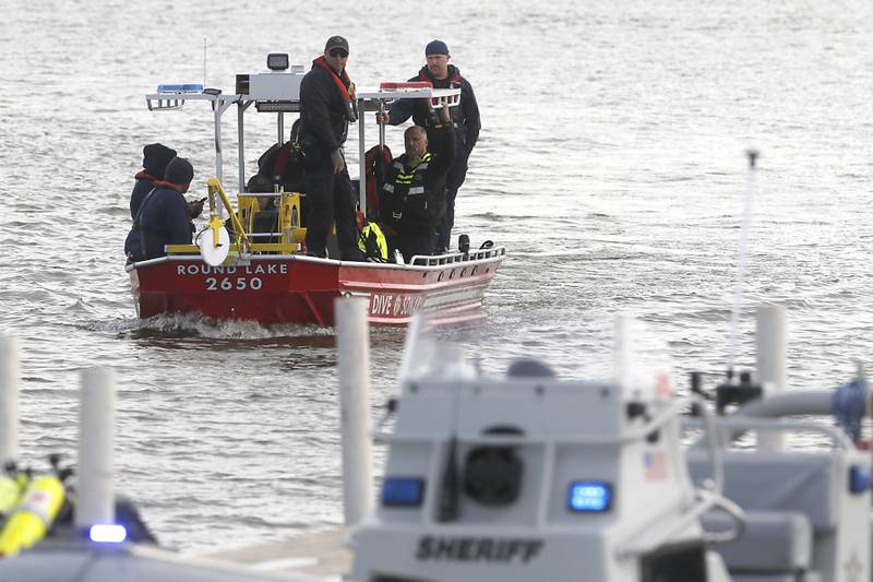 A crew heads back to the dock as divers from the Antioch Fire Protection District and a sonar team from the Illinois Department of Natural Resources continue searching Tuesday, Oct. 7, 2025, on Fox Lake near Antioch for a man thrown from a boat he was test driving Monday night.