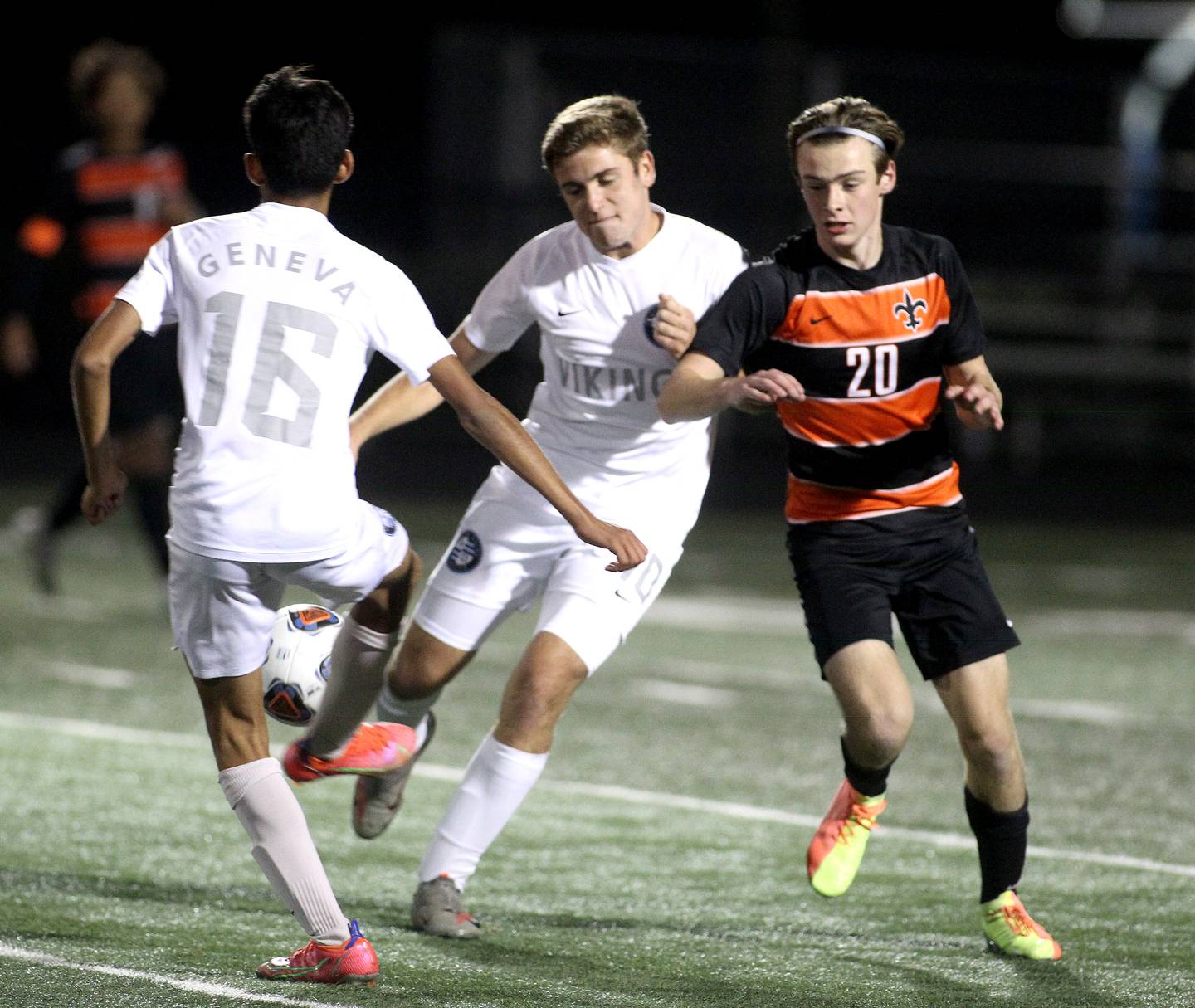 Geneva's Nicolas Plata (16) and Nathan Branstad (10) get the ball away from St. Charles East's Mason Brockmeyer (20) during the Class 3A Addison Trail Sectional semifinal Wednesday, Oct. 27, 2021.