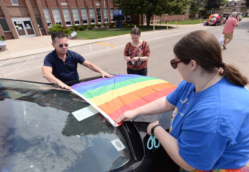 (left-right) Jousef Mondragon, Rebecca Lewis and Quinn Stitt of Berwyn get one of the vehicles ready for the Berwyn Pride Parade Saturday June 15, 2024.