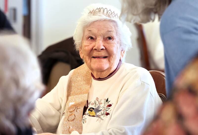 Heritage Woods of DeKalb resident Phyllis Fawcett, chats with well-wishers during her surprise 100th birthday party Thursday, March 21, 2024, at Heritage Woods.