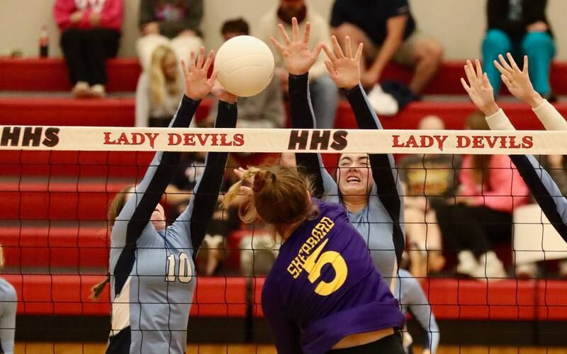 Bureau Valley's Kate Salisbury and Keely Lawson put a block on Sherrard's McKenna Blackwell Tuesday night at Hall.