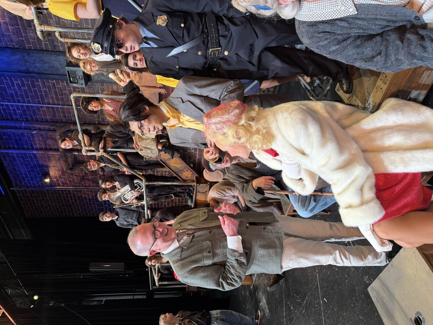 Cary-Grove High School Musical Director Rob Boncosky directs the cast of "Urinetown" before a show on March 8, 2026.