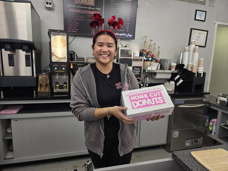 KC Buan, a five-year employee at Home Cut Donuts in Joliet, holds a box of 
 Paczki, a traditional jelly-filled, doughnut-like pastry, which many people enjoy before the start of the Christian Lent, on Saturday, Feb. 14, 2026.