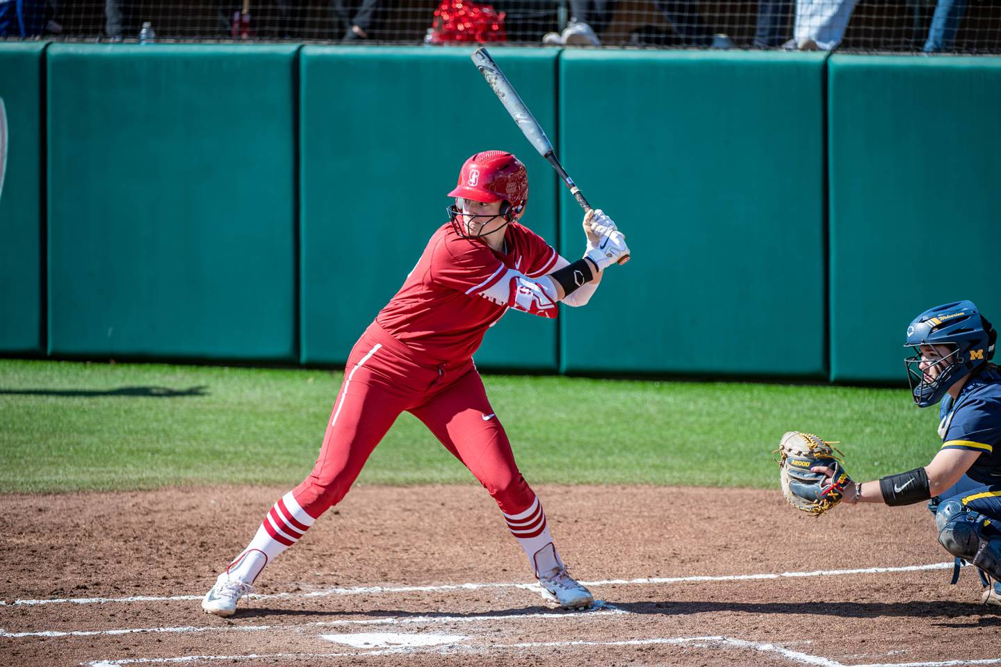 Emily Schultz hits during a game between Michigan and Stanford Softball at Boyd and Jill Smith Family Stadium on February 25, 2023 in Stanford, California. Schultz, a former Oswego East star, and Stanford will be playing in the College World Series this week.