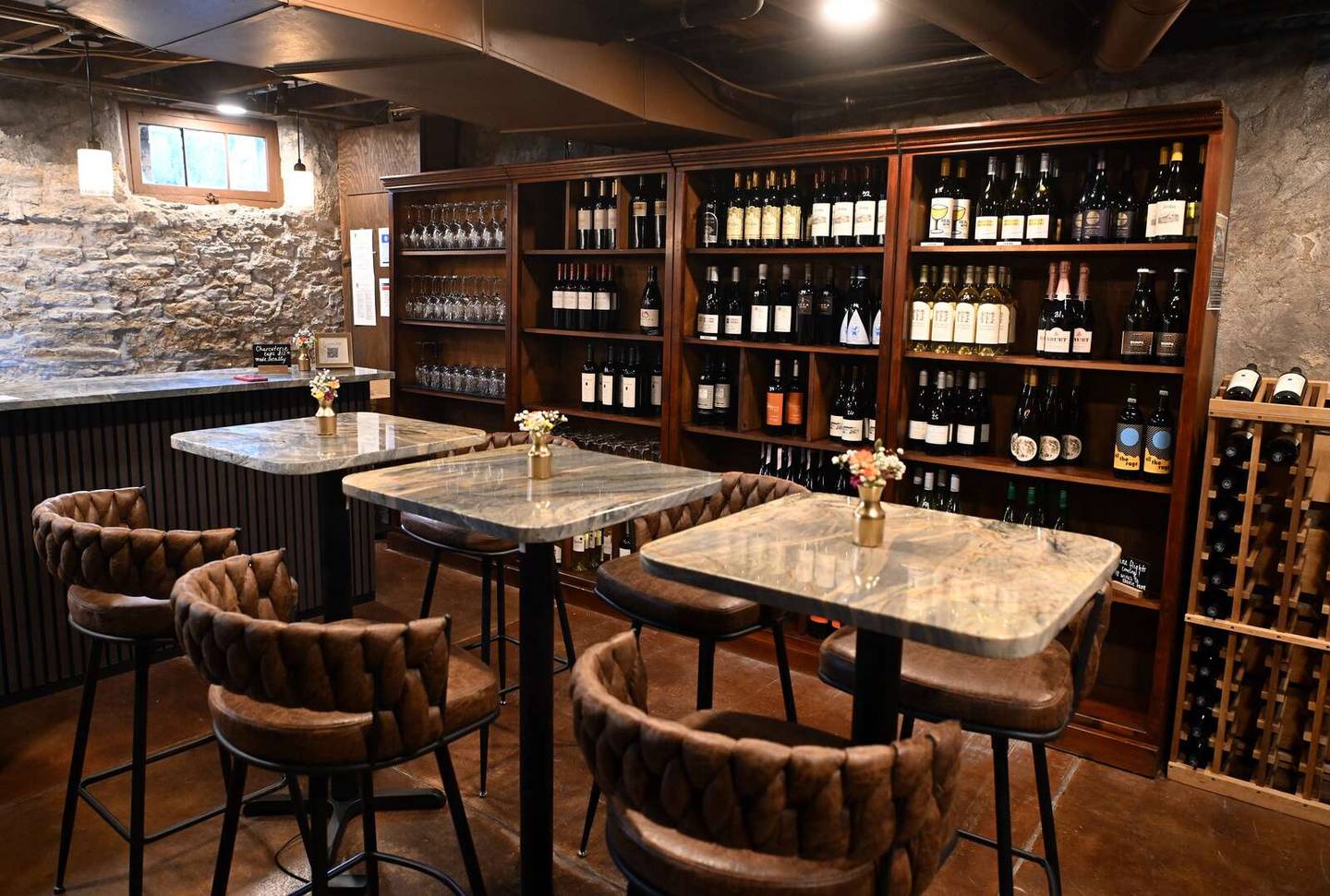 The front room of the reopened Geneva Wine Cellar & Tasting Room features a new bar and stone accent walls.