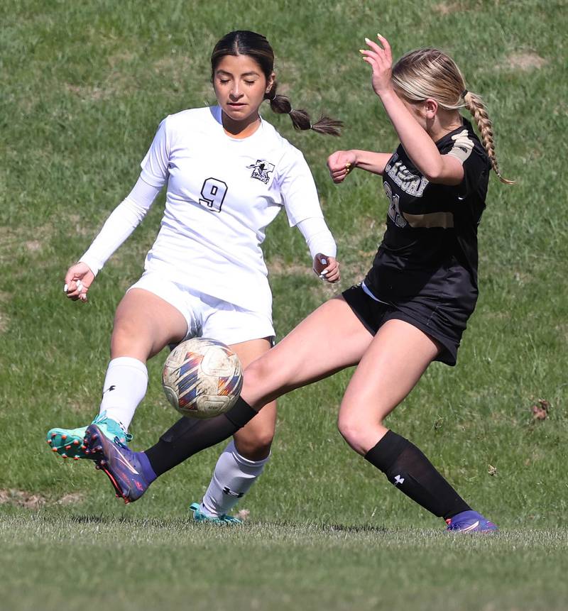 Kaneland's Alondra Mendoza (left) and Sycamore's Kelsie Ryder try to gain control of the ball during their game Monday, April 14, 2025, at Sycamore High School.