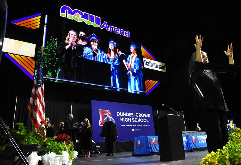 Dundee-Crown High School senior Michelle Arreguin is projected on the big screen while singing the National Anthem during the graduation ceremony on Saturday, May 21 at the Now Arena in Hoffman Estates.
