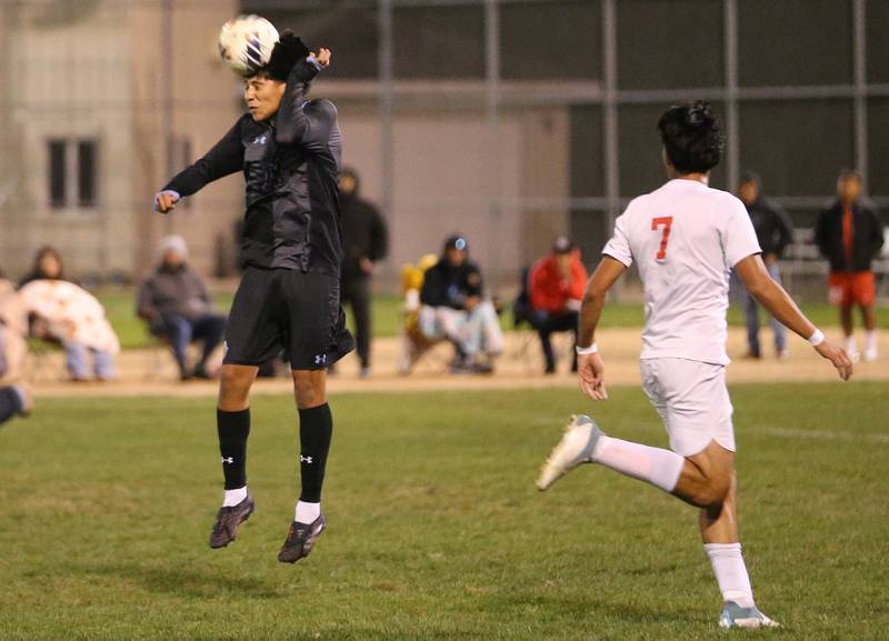 Kankakee's Luisangel Pereda puts a header on the ball in front of Ottawa's Jorge Lopez during the Class 2A Regional semifinal game on Monday, Oct. 20, 2025 at Ottawa High School.