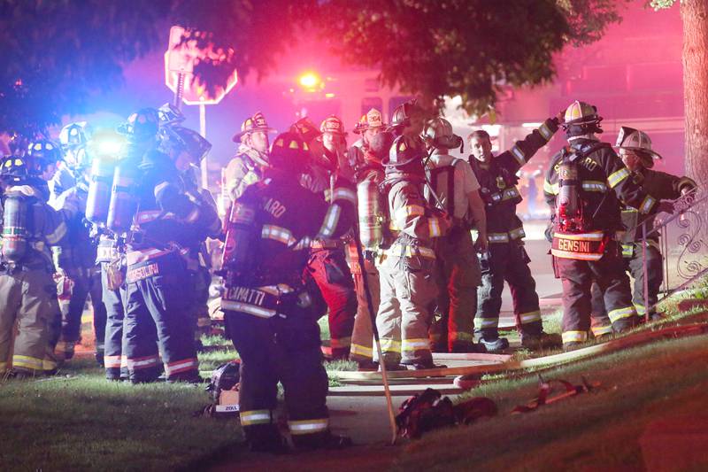 Firefighters work the scene of a structure fire in the 100 block of West Cleveland Street on Thursday, May 15, 2025 in Spring Valley. The fire broke out shortly before 8:30p.m. Fire departments from La Salle Bureau and Putnam Counties responded to the scene. A mutual aid box alarm system (MABAS) call was issued prompting the response.