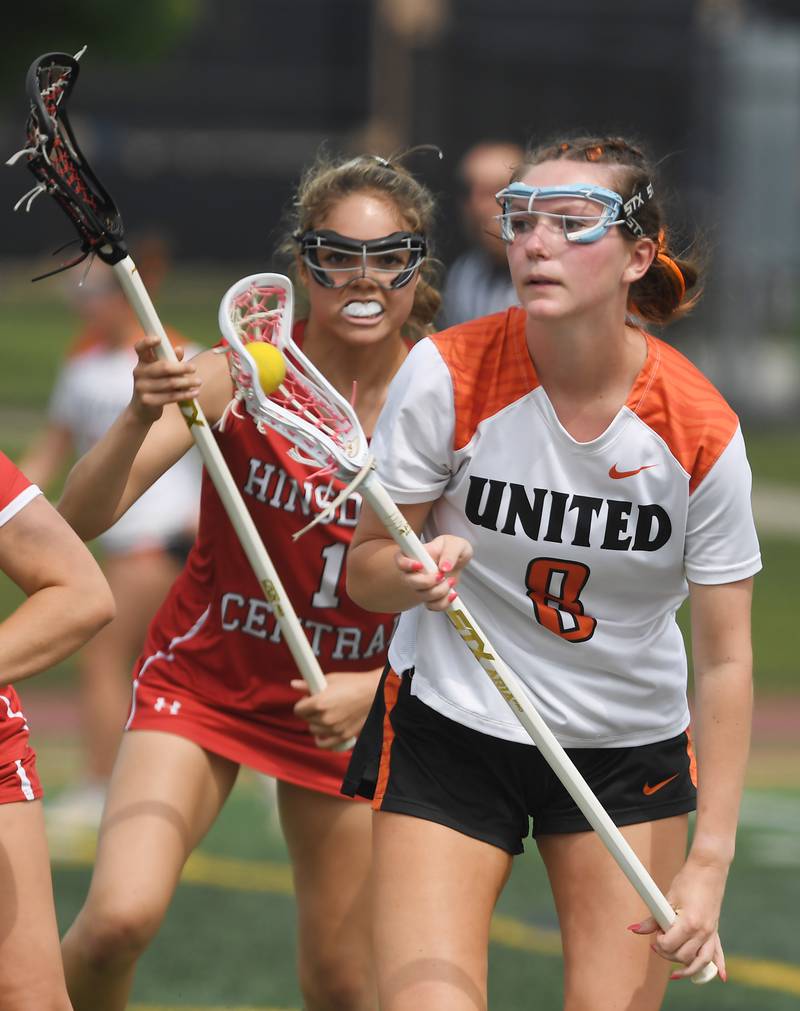 Crystal Lake Central Coop's Izzy Jackson, front, looks to get past Hinsdale Central's Ella Parker-Briones during the third-place game of the girls lacrosse state finals at Hinsdale Central High School on Saturday, June 7, 2025.