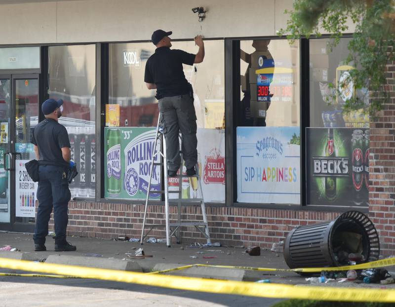 Police investigators mark an apparent bullet hole on the front of Five Star Pantry at 10S620 Kingery Hwy. in Willowbrook on Monday, June 20. 2023. There was  a mass shooting there early Sunday morning as a unsanctioned party took place in the parking lot.