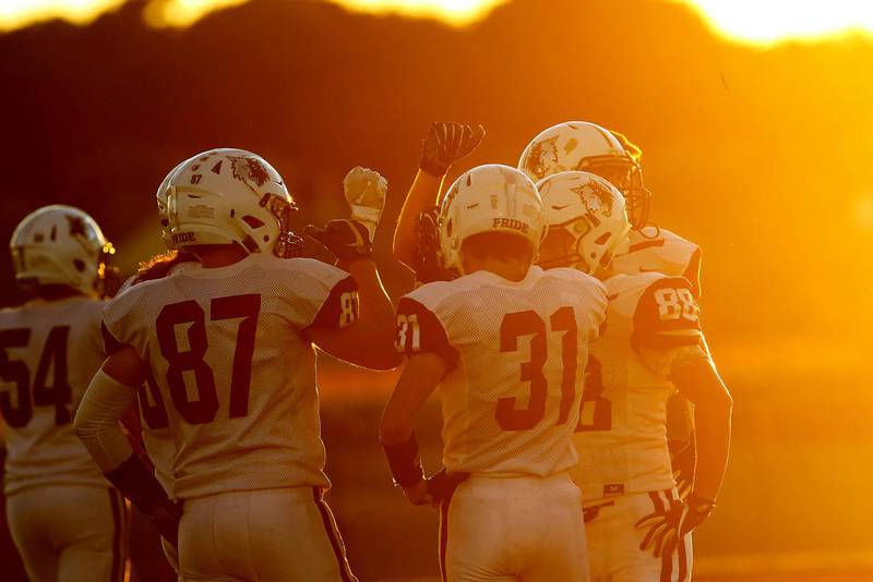 The Prairie Ridge Wolves bask in the setting sun as they prepare to take on Huntley during their week 3 football game at Huntley High School on Friday, Sep. 13, 2019 in Huntley.  Huntley won 28-24.