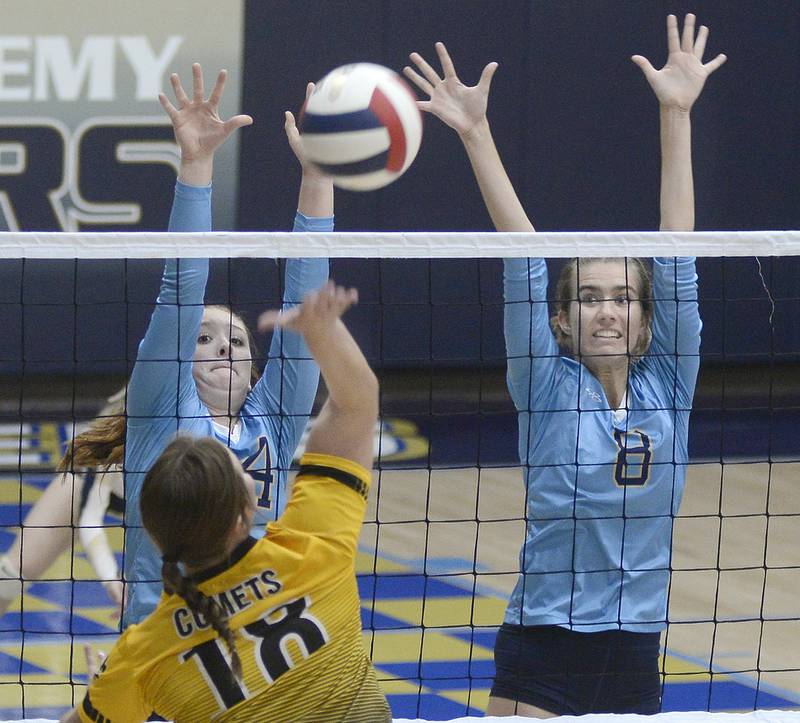 Marquette’s Maera Jimenez and Mary Lichtenberg prepare a block on a shot by Reed Custer during the first match Monday at Marquette.