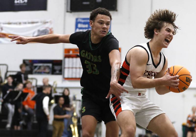 McHenry's Kyle Maness grabs a rebound in front of Crystal Lake South's Cooper Buelnaduring a Fox Valley Conference boys basketball game on Wednesday, Dec. 11, 2024, at McHenry High School.