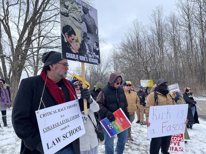 Protesters gather Saturday, Feb. 25, 2023, outside of the Holiday Inn in Crystal Lake to protest a speaking event featuring conservative activist Charlie Kirk.